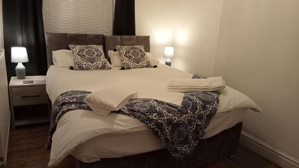 a bedroom with a large bed with pillows at Planet 9 in Warrington