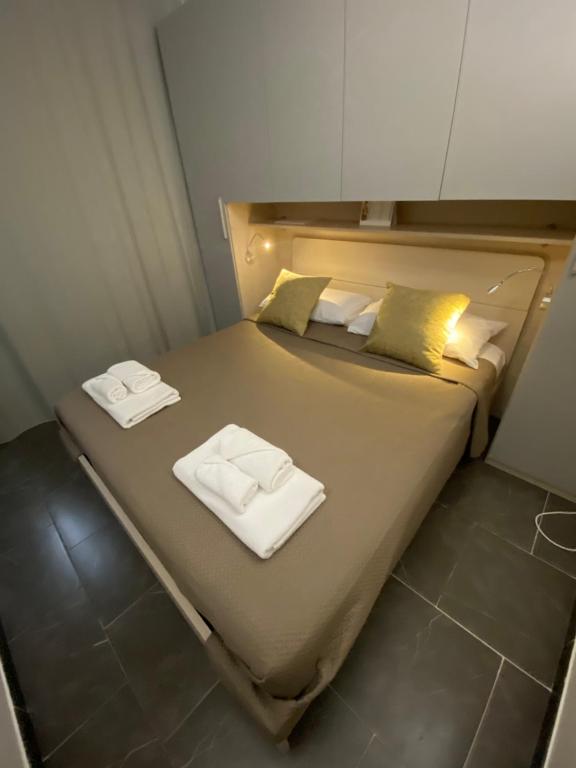 a bedroom with a bed with towels on it at Little House in Reggio di Calabria