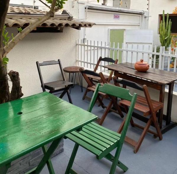 a picnic table and chairs on a patio at HOSTEL YA DUDU E BISTRO in Cuiabá