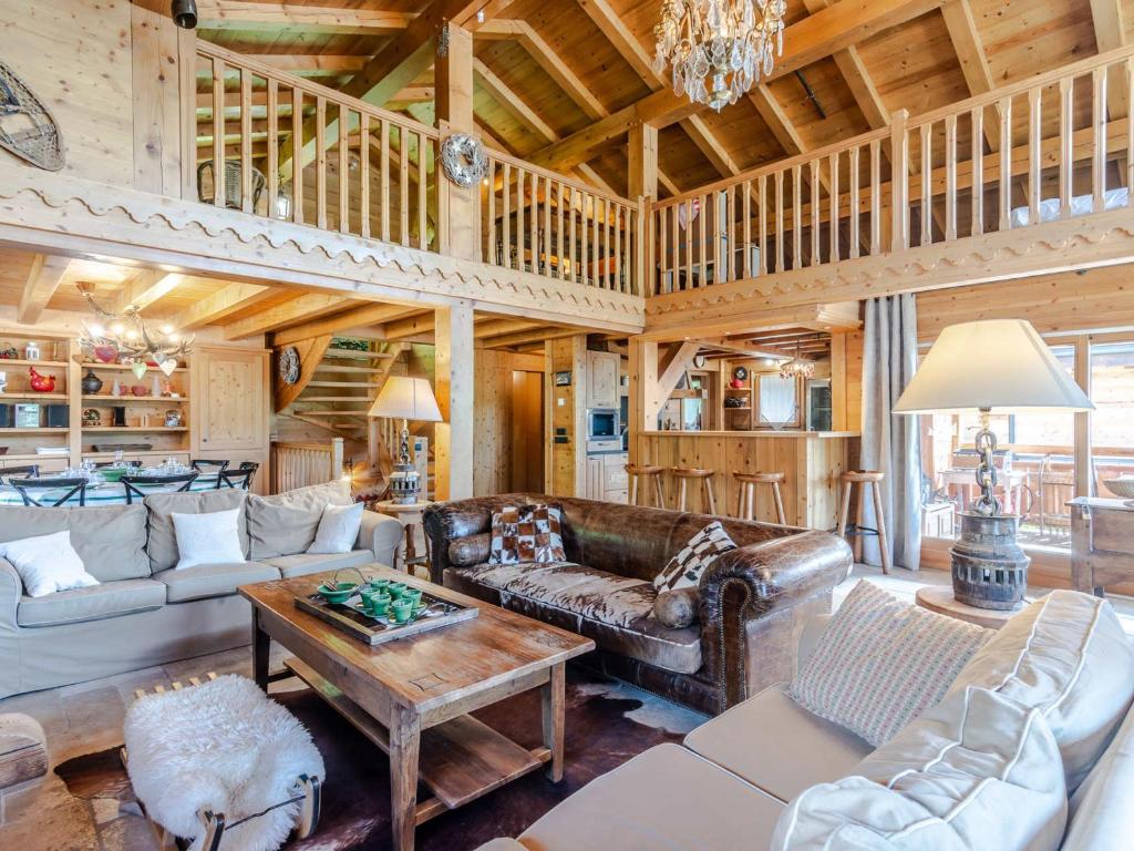 a living room with a couch and a table at Chalet Morzine, 7 pièces, 14 personnes - FR-1-754-8 in Morzine