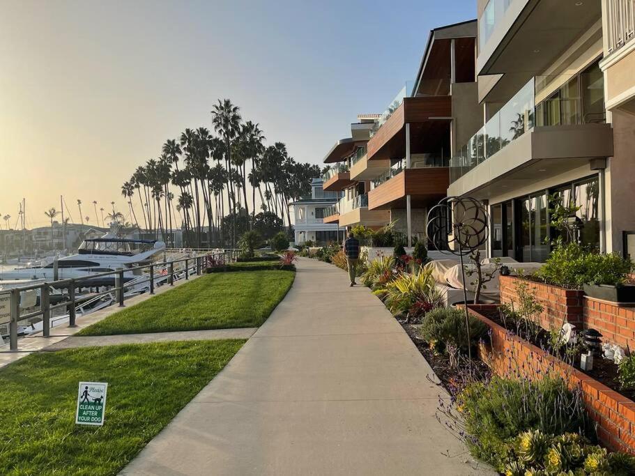 a sidewalk next to a building with a marina at Island Vibes 1 bedroom in LongBeach-30 days min. in Long Beach