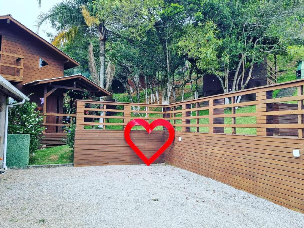 a red heart is leaning against a fence at Suite Farol do Arvoredo in Governador Celso Ramos