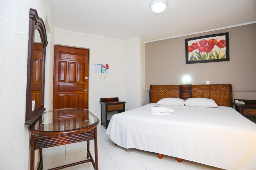 Postel nebo postele na pokoji v ubytování Hotel Parador