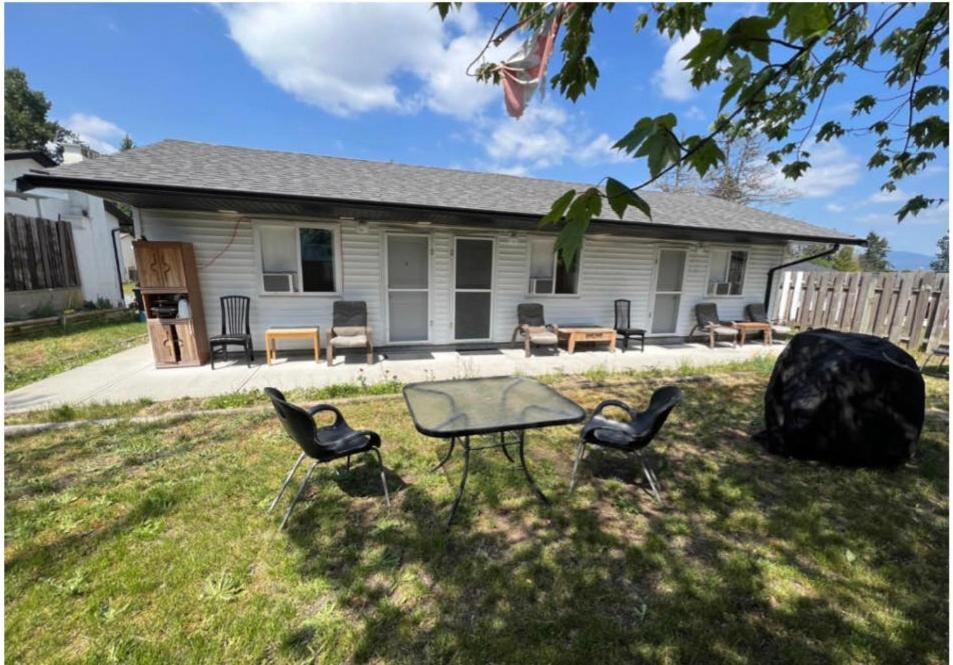 a house with a table and chairs in the yard at Guest Suite Private Retreat- Honeymoon Suite- J-1 in Abbotsford