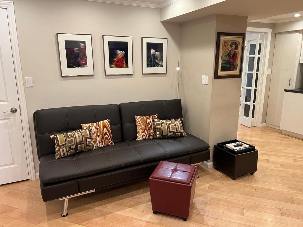 a black couch in a living room with pictures on the wall at Stunning SanFran Casa close to Center and steps from Ocean in San Francisco