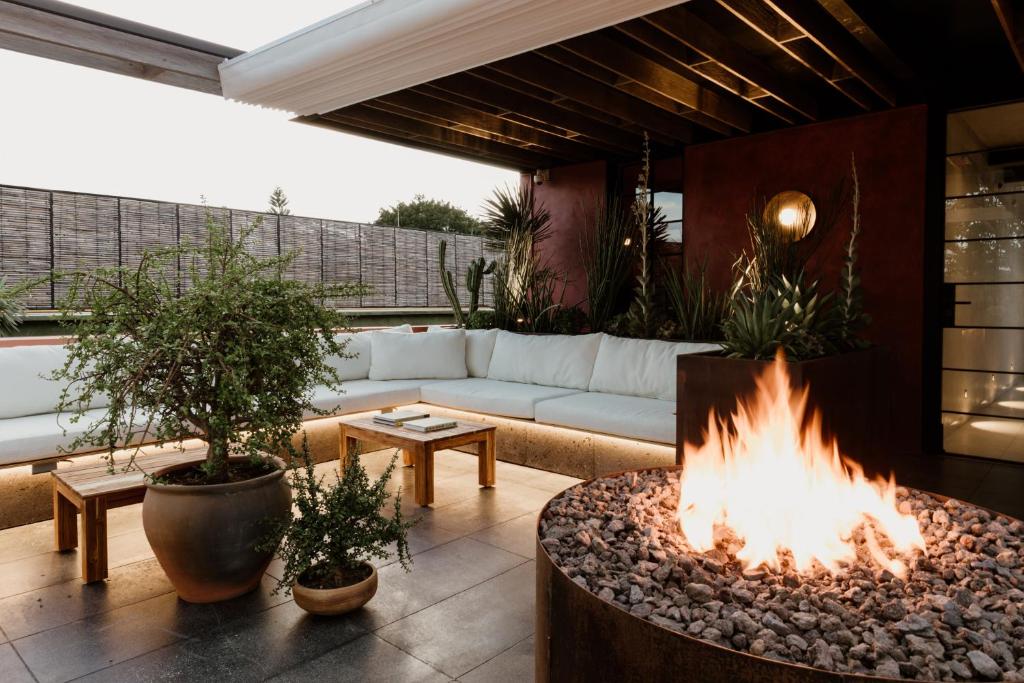 a living room with a fire pit and a couch at Majagua Hotel Boutique -Adults Only in Oaxaca City