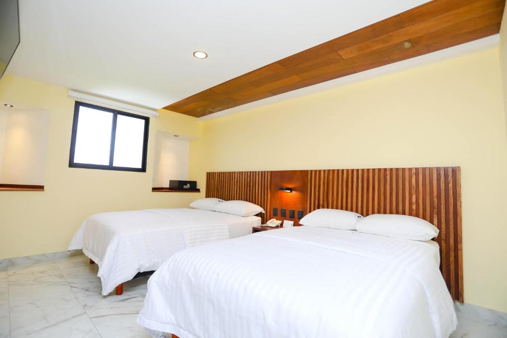 Postel nebo postele na pokoji v ubytování Hotel Parador