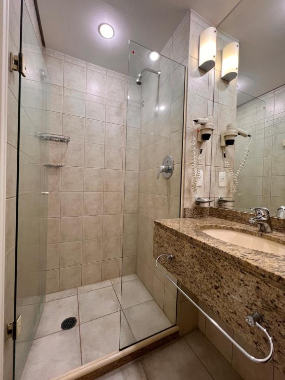 a bathroom with a shower and a sink at HOTEL PERDIZES - FLAT Executivo - 1204 in São Paulo