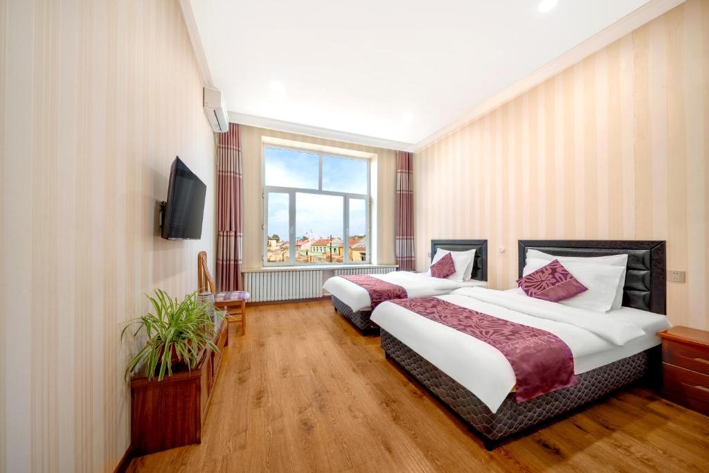 Postel nebo postele na pokoji v ubytování Harbin Binpeng Inn - Harbin Taiping International Airport