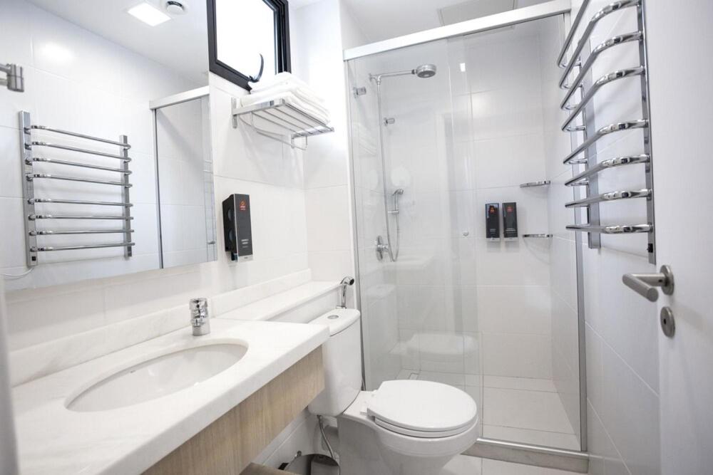 y baño con lavabo, aseo y ducha. en Apartamento Mondial Salvador, en Salvador