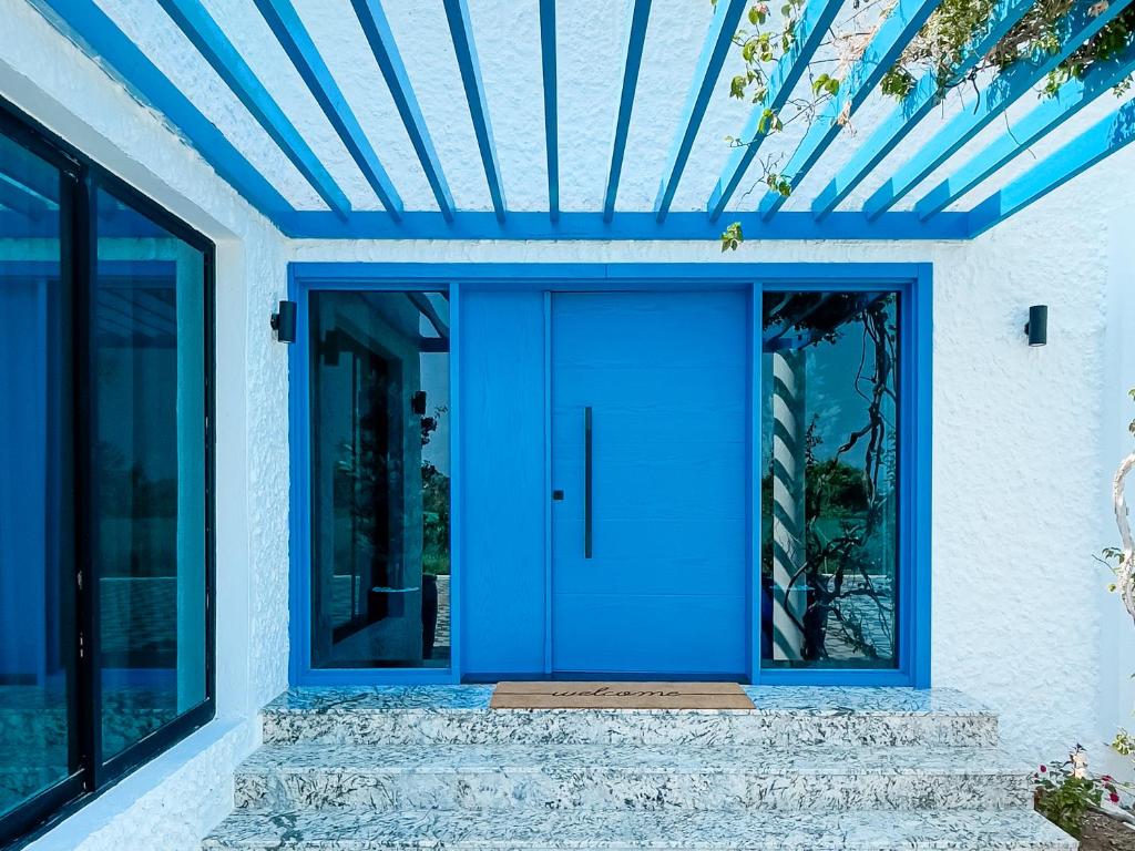 a blue door on a house with a blue ceiling at Moon mountain villa 