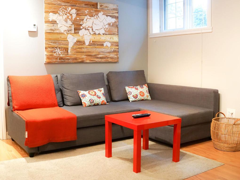 a living room with a couch and a red table at Free Parking - Great 1BR near Henri Bourassa Metro in Montreal