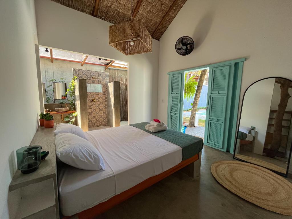 a bedroom with a large bed and a large window at Villa Parazinho in Paracuru