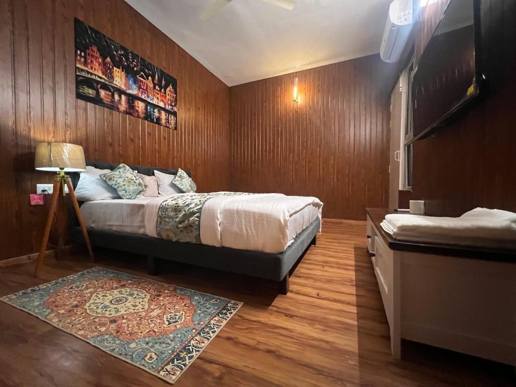 a bedroom with a large bed and a rug at Metro Nook in Lucknow