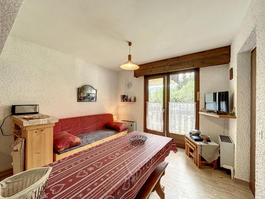 a living room with a red couch in a room at Appartement Combloux, 2 pièces, 5 personnes - FR-1-560-61 in Combloux