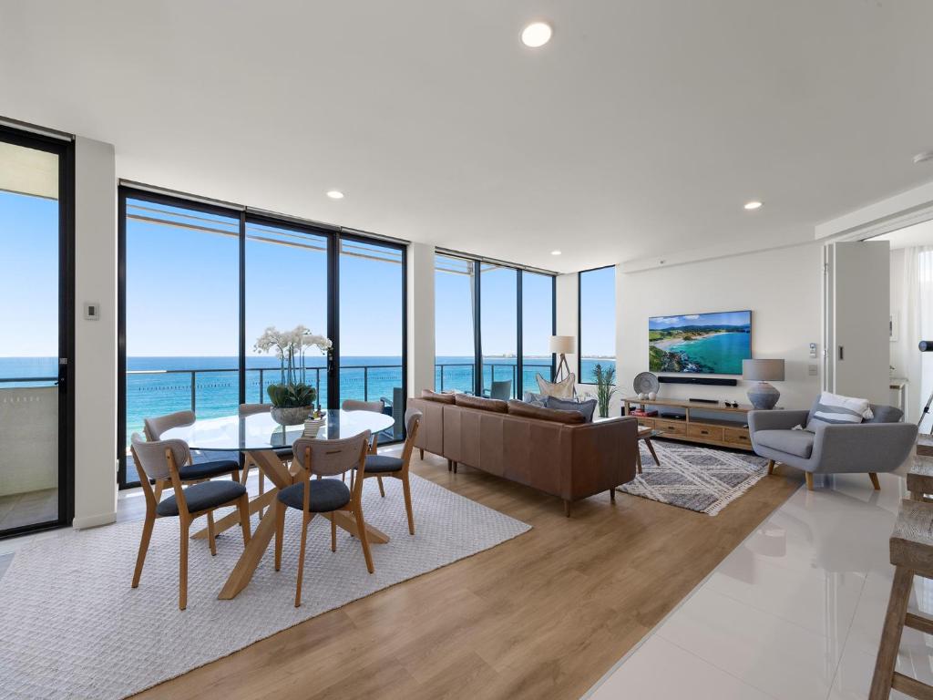 a living room with a view of the ocean at Beach on Sixth in Maroochydore