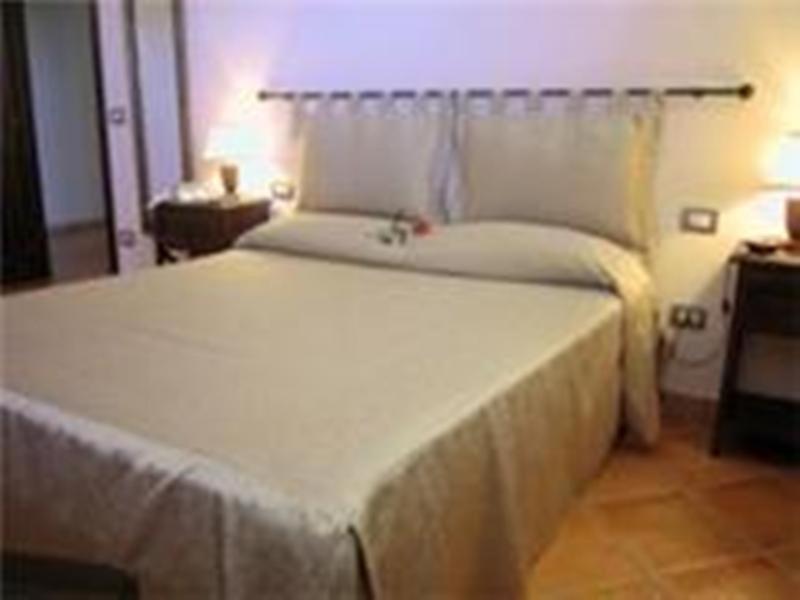 Postel nebo postele na pokoji v ubytování Residence Hotel La Commenda