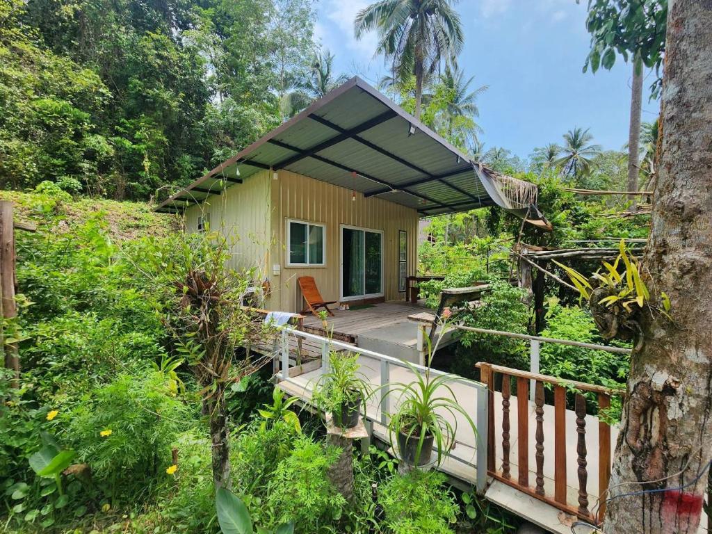 a small house in the middle of a forest at Lung peiyk homestay in Ban Bang Bao
