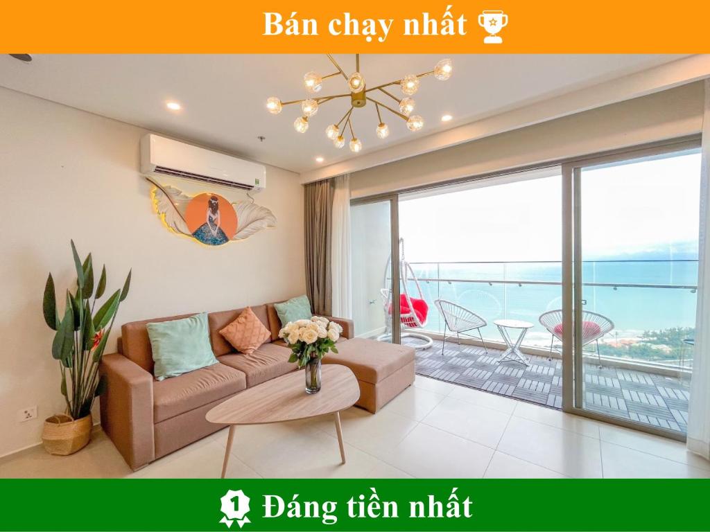 a living room with a couch and a view of the ocean at The Song Luxury Apartment by Lisa House in Vung Tau