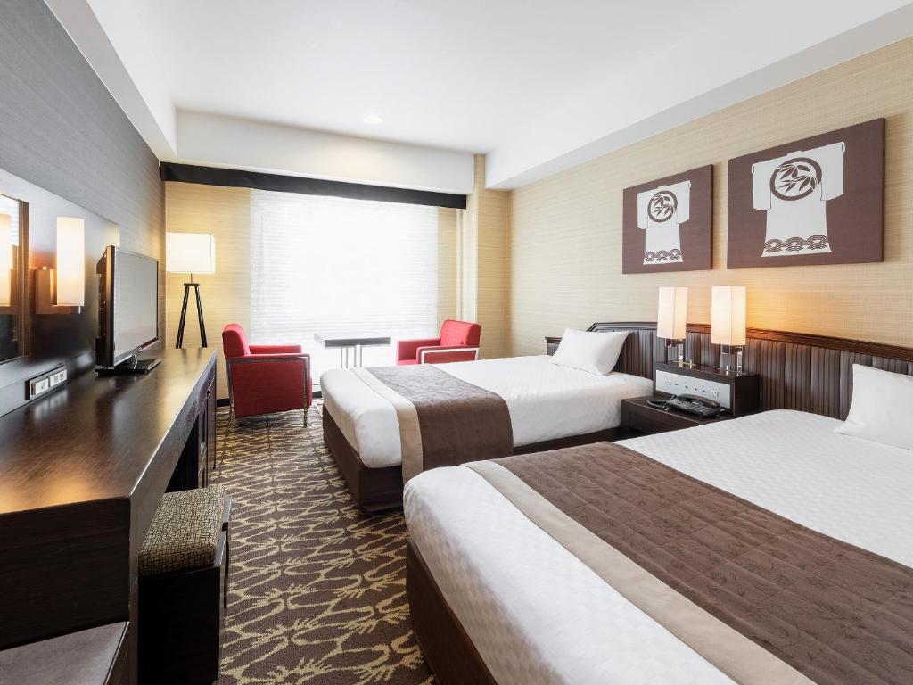 Postel nebo postele na pokoji v ubytování Hotel New Hankyu Kyoto