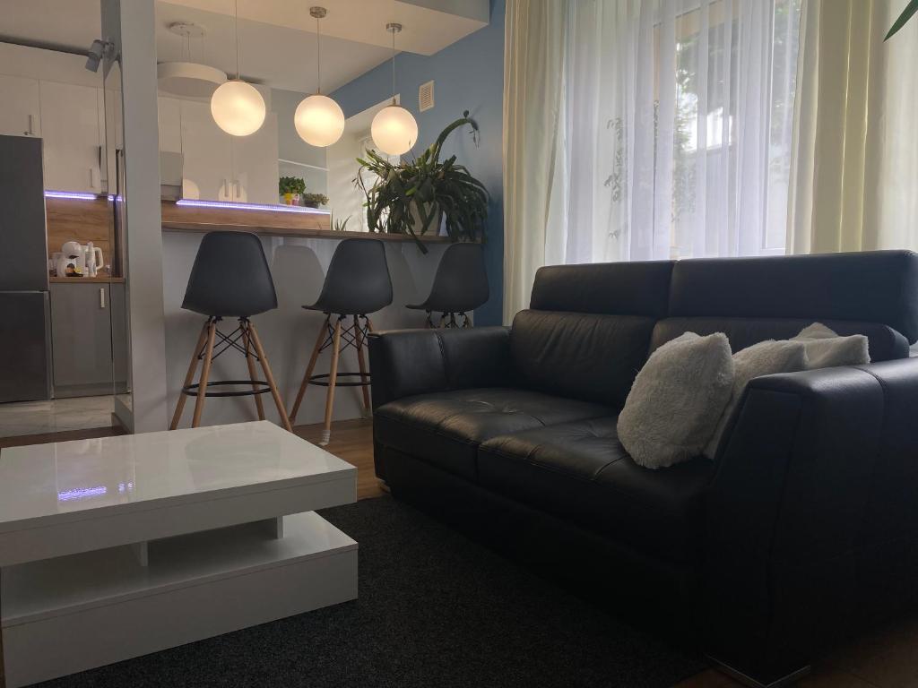 a living room with a couch and a table at Rezekne Lux Apartments in Rēzekne