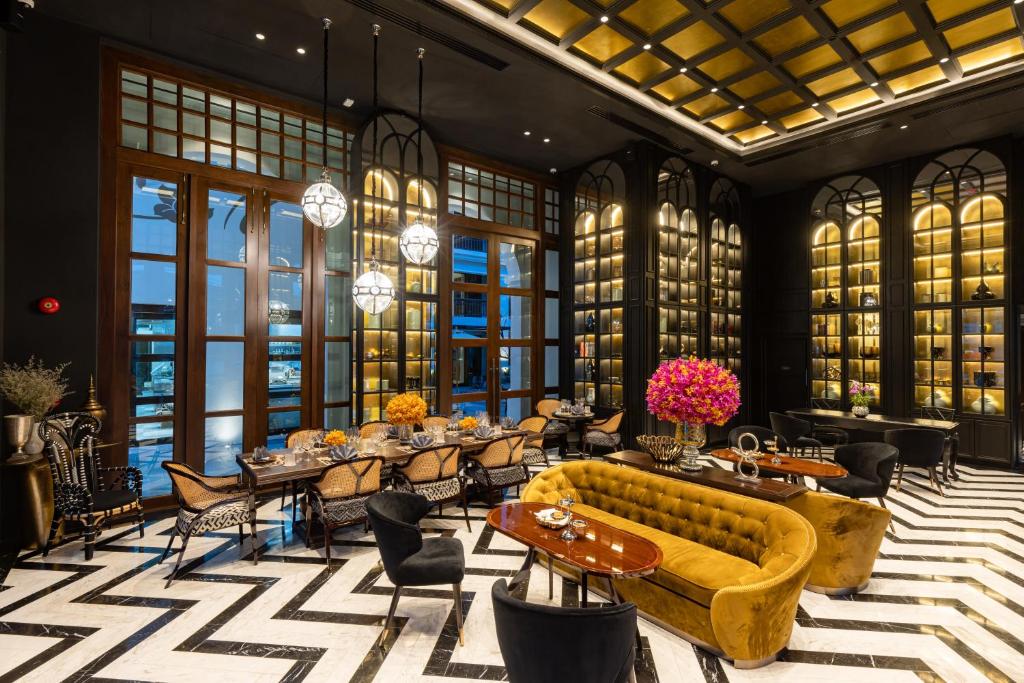 A spacious-looking lounge and library lined with illuminated display shelves.