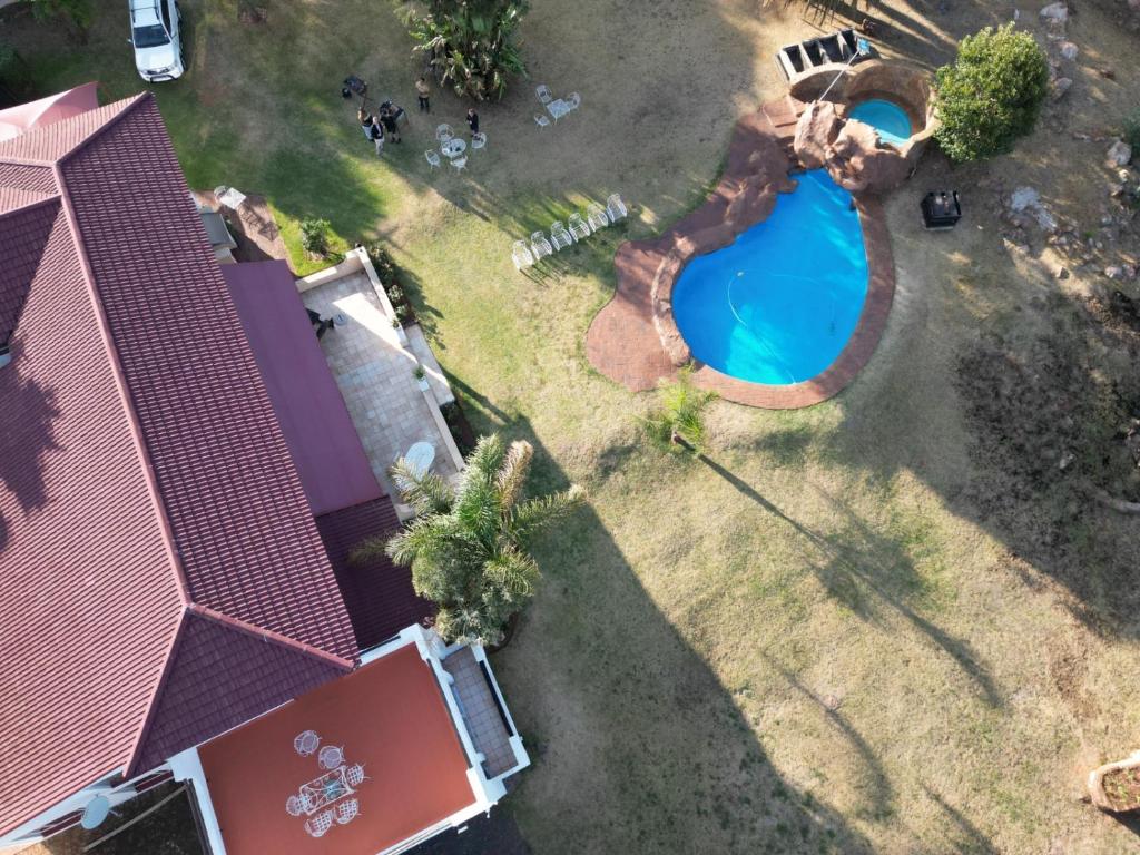 an overhead view of a swimming pool in a yard at Jacaranda Self Catering Chalets in Krugersdorp