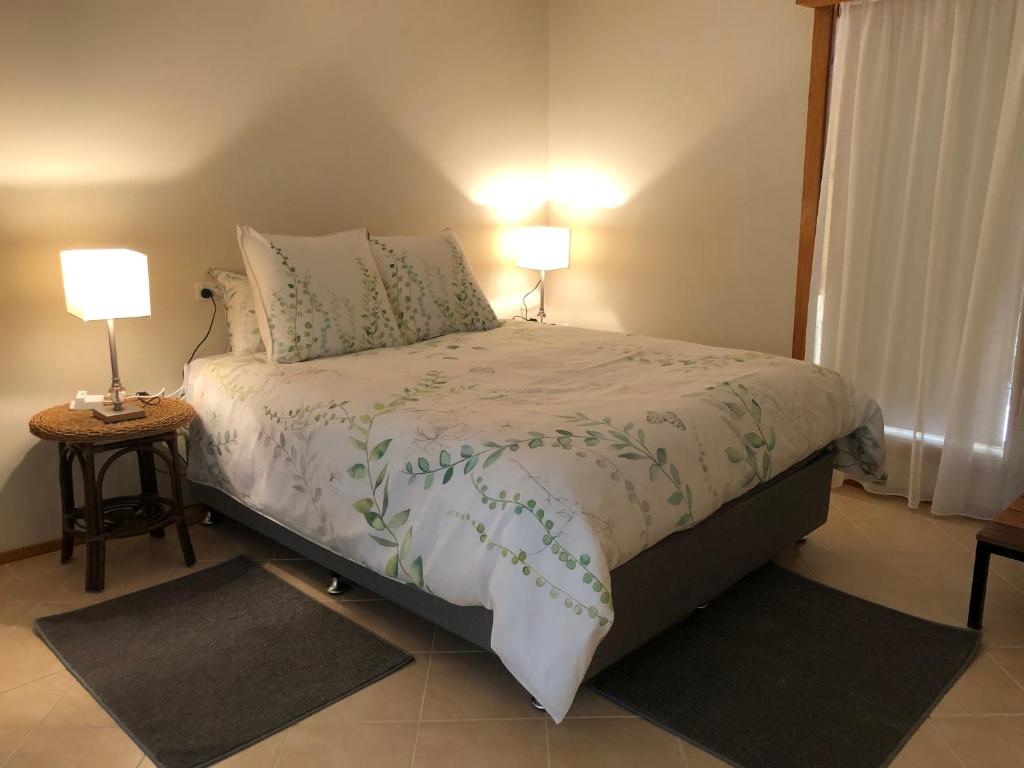 a bedroom with a bed with two lamps on it at Copeland Cabins in Copeland