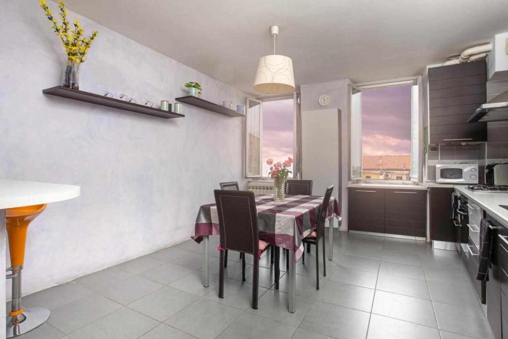 a dining room with a table and chairs in a kitchen at HOME 41 con vista mare in Trieste