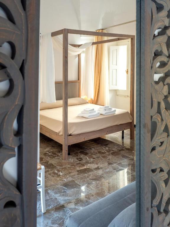 Postel nebo postele na pokoji v ubytování Lucente Rooms & Suites