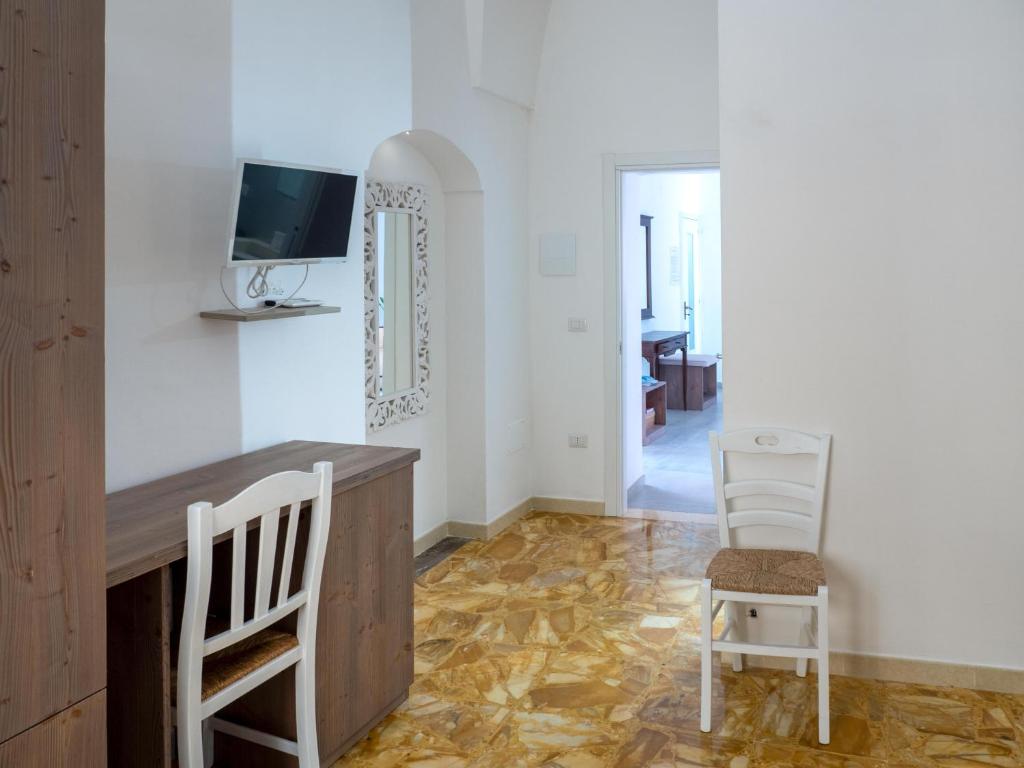 TV a/nebo společenská místnost v ubytování Lucente Rooms & Suites