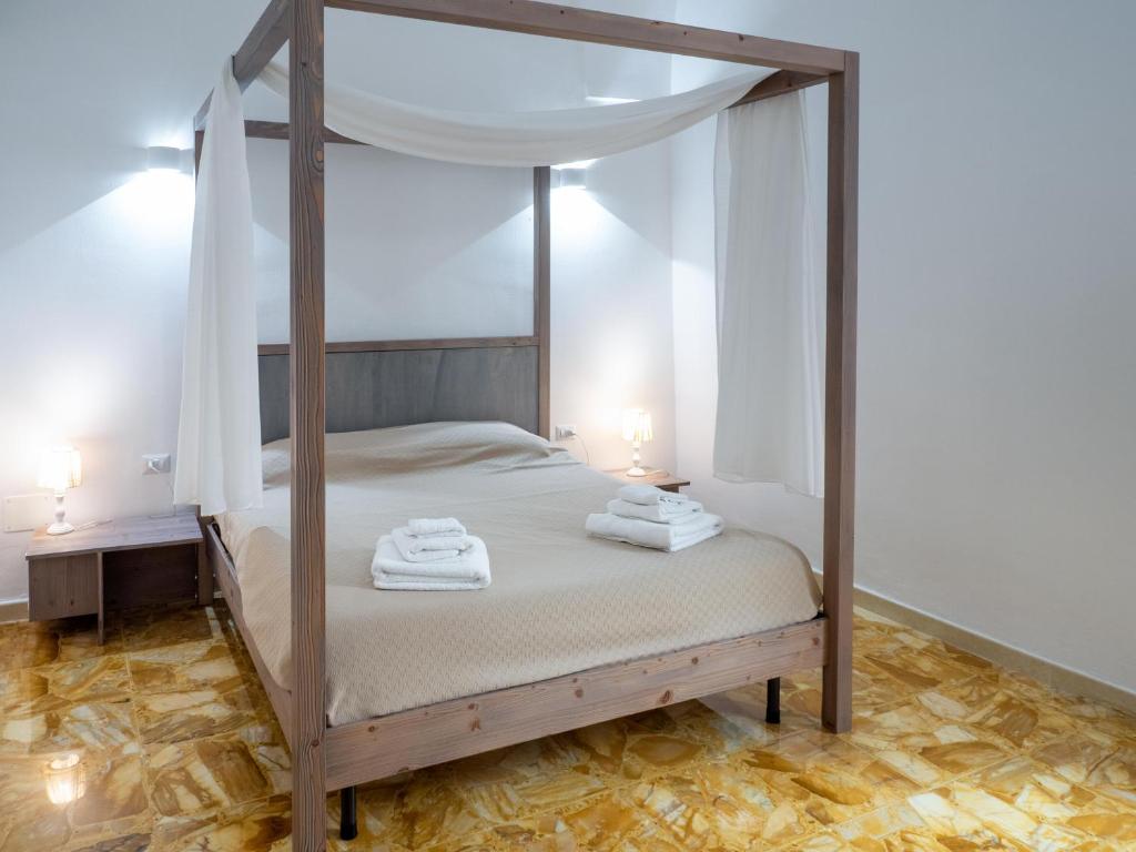 Postel nebo postele na pokoji v ubytování Lucente Rooms & Suites