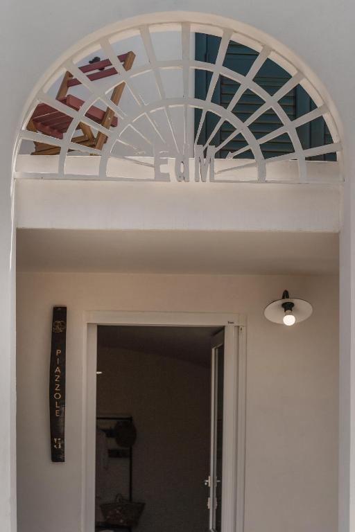 a ceiling over a door with a glass at Cala Cala Rooms,Restaurant & Farm Experience in Procida