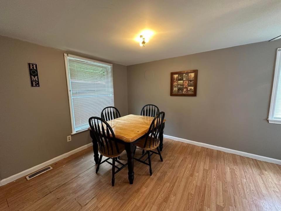 a dining room with a wooden table and chairs at Jeans Place in Northfork