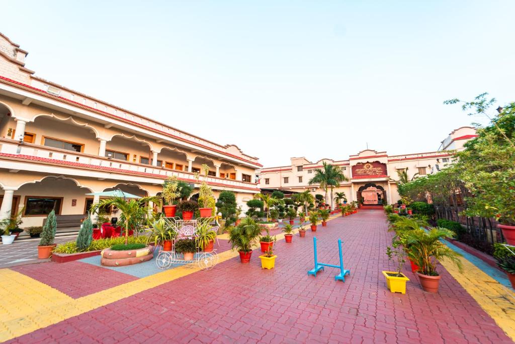 a building with a courtyard with potted plants in it at Hotel Royal Palace in Sāgar