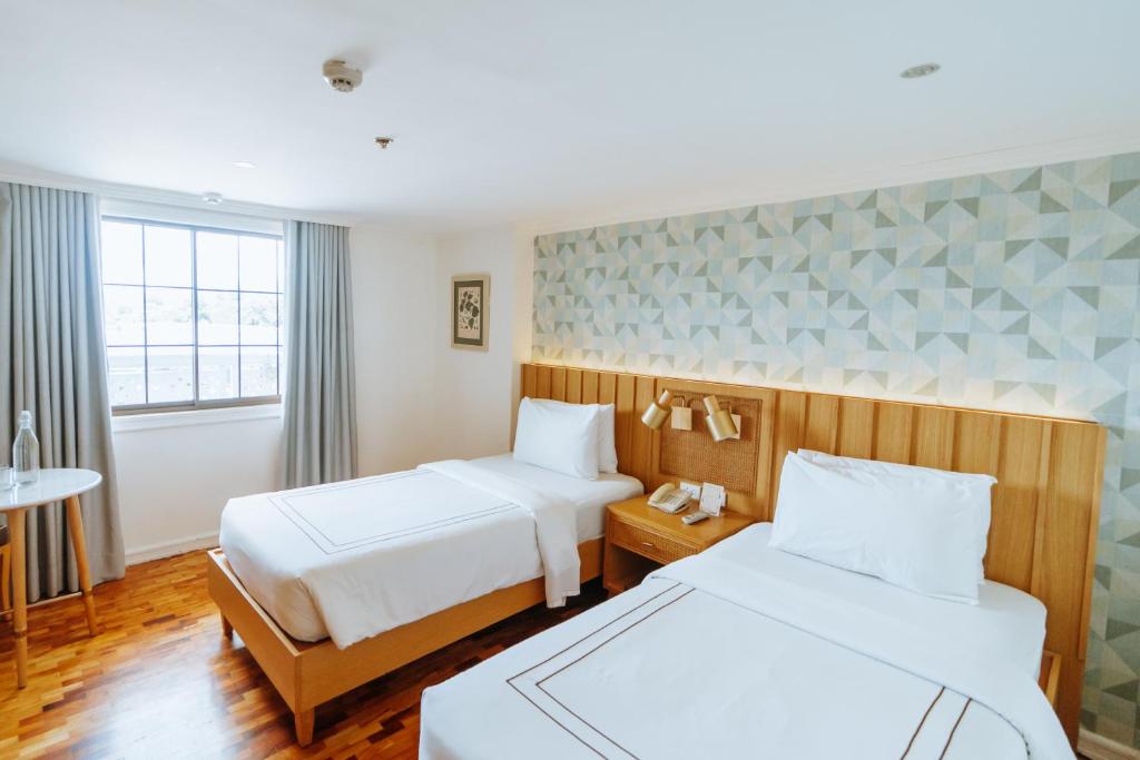 Postel nebo postele na pokoji v ubytování Sugarland Hotel