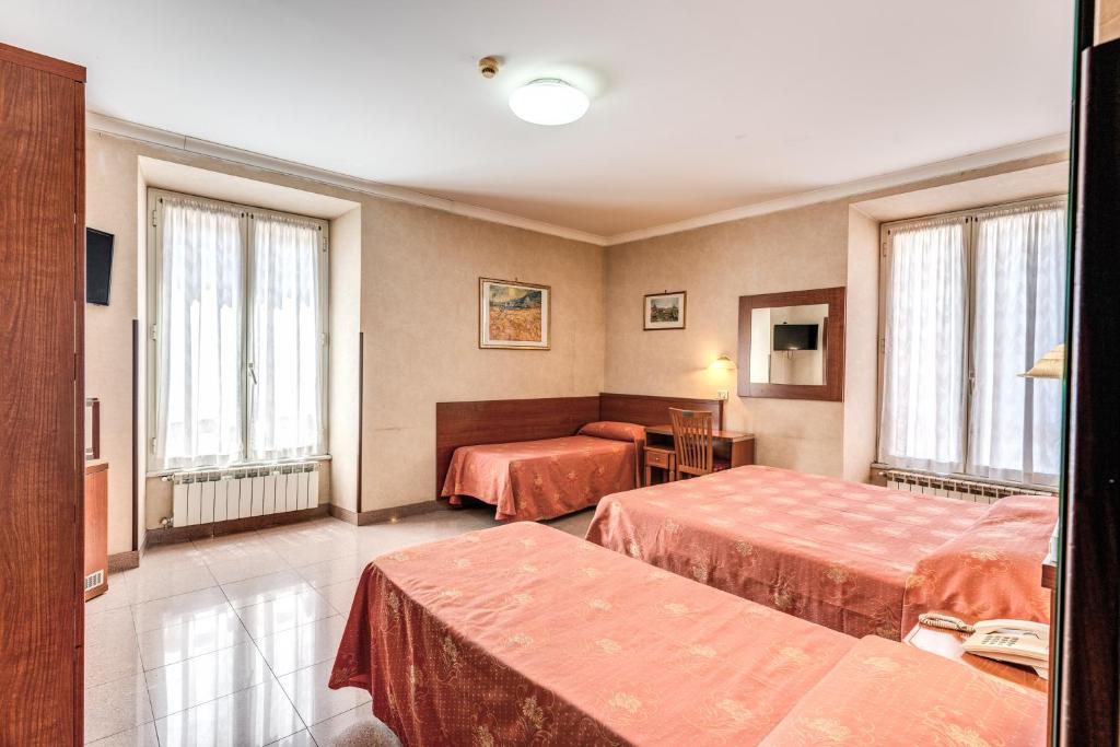 Postel nebo postele na pokoji v ubytování Hotel Milo