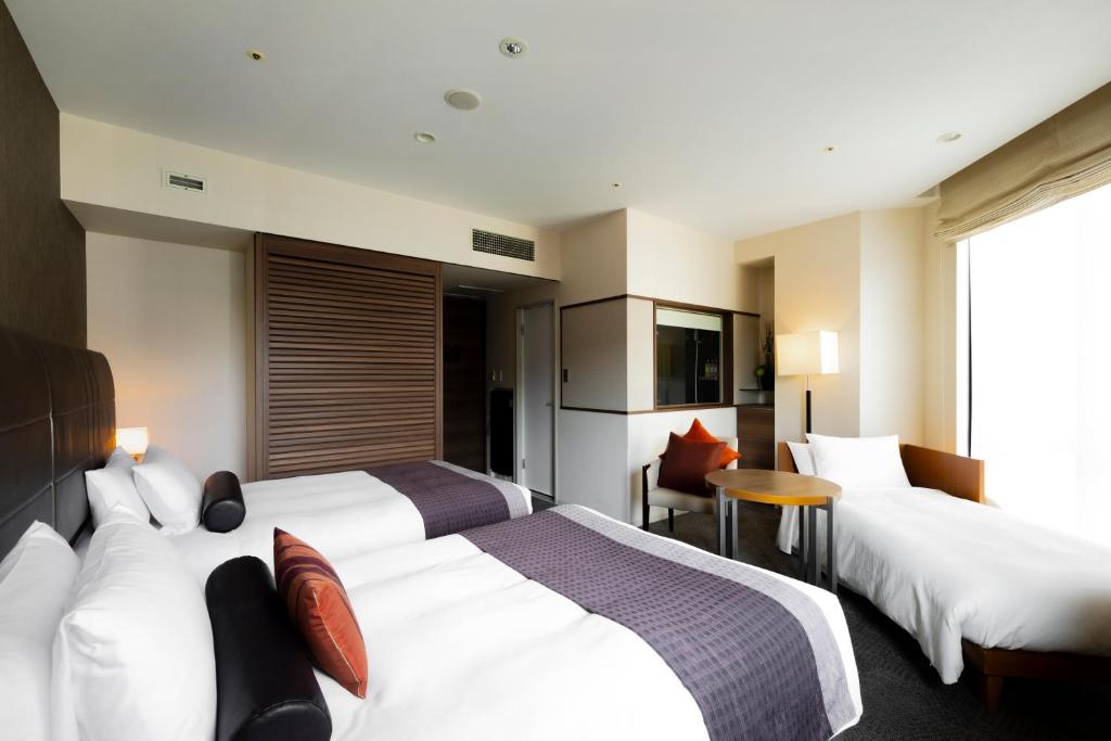 a hotel room with two beds and a table at Tokyu Stay Kamata - Tokyo Haneda in Tokyo