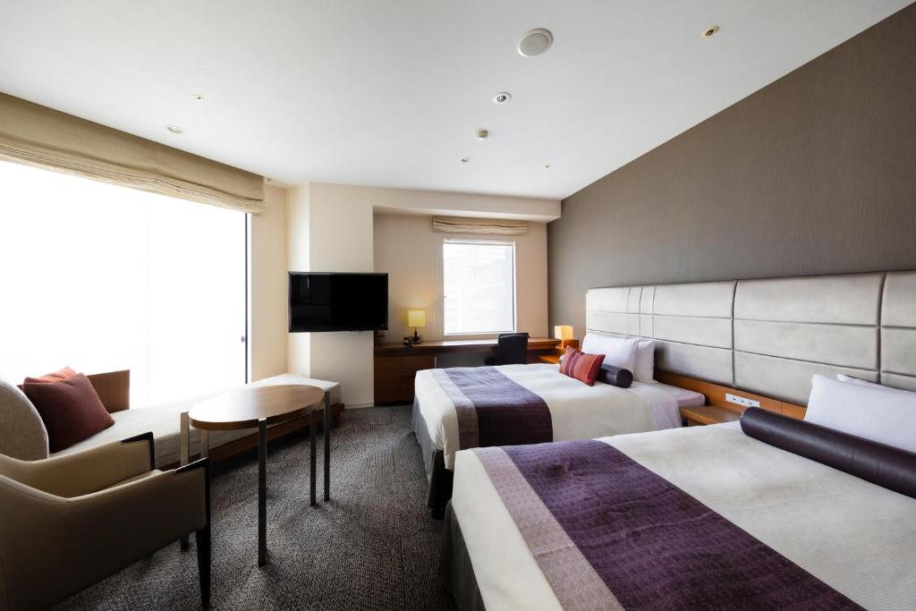 a hotel room with two beds and a tv at Tokyu Stay Kamata - Tokyo Haneda in Tokyo