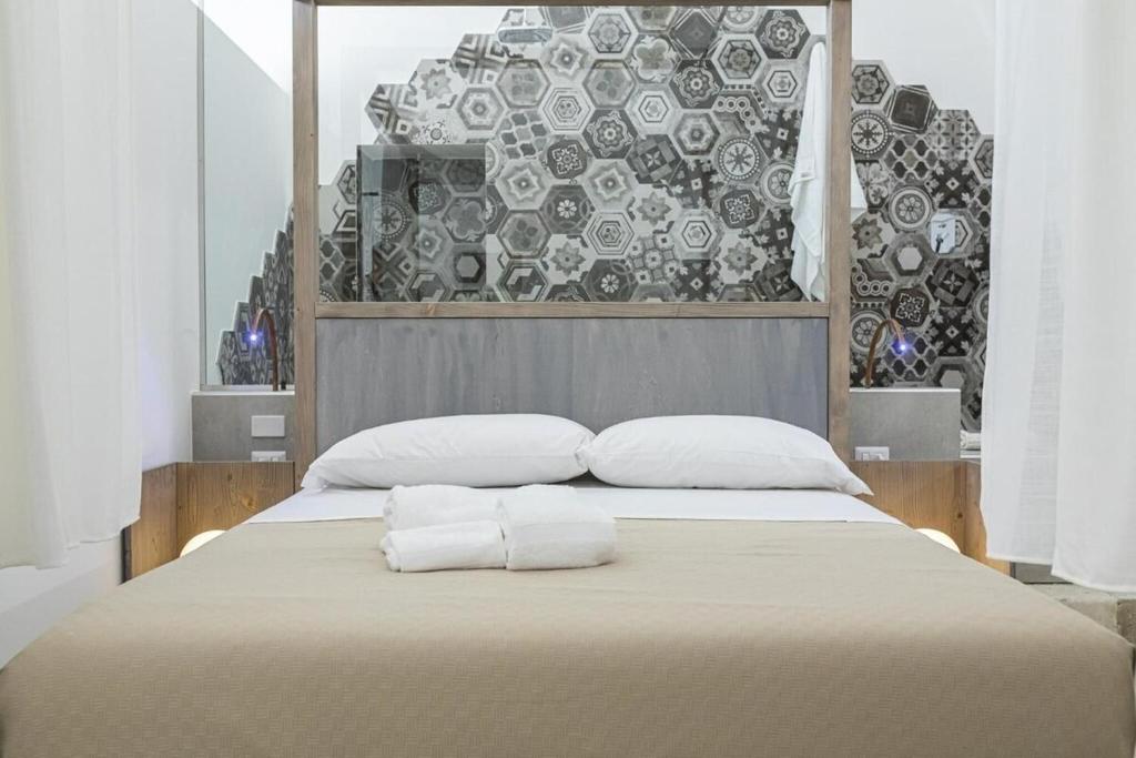 Postel nebo postele na pokoji v ubytování Lucente Rooms & Suites