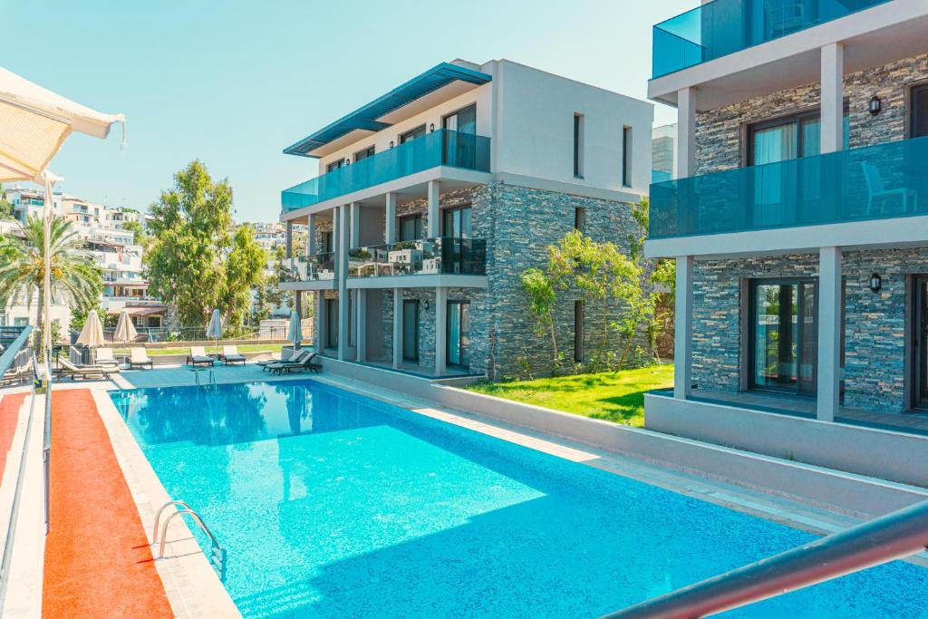 a swimming pool in front of a house at ZEF RESIDENCE in Bodrum City