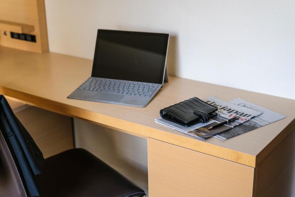 a laptop computer sitting on top of a desk at Tokyu Stay Kamata - Tokyo Haneda in Tokyo
