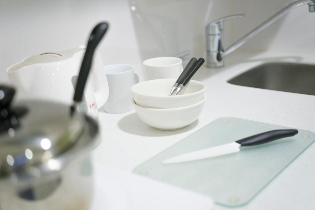 a kitchen counter with a bowl and utensils on it at Tokyu Stay Kamata - Tokyo Haneda in Tokyo