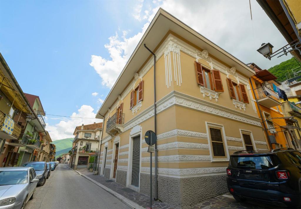 een geel en wit gebouw aan de straatkant bij Orsini: tre camere da letto, 2 bagni in Luco neʼ Marsi