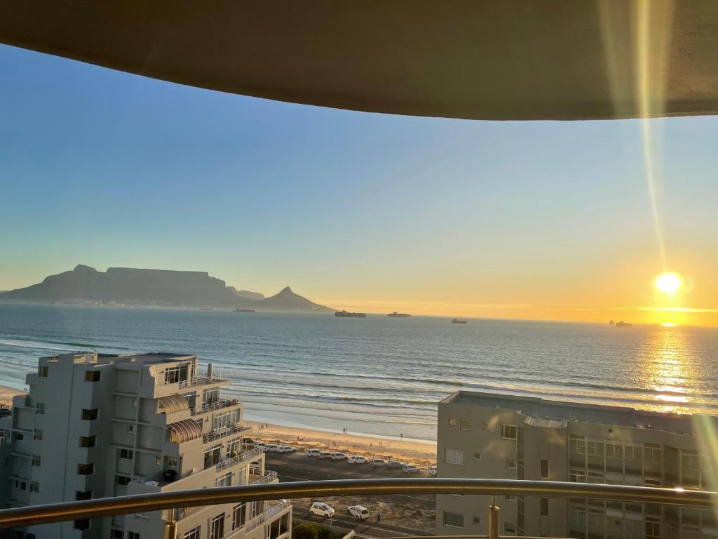 a view of the beach and the ocean from a balcony at Ocean View B1001 in Bloubergstrand