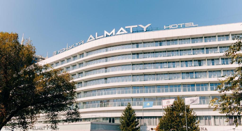 a large building with the almark hotel sign on it at Almaty Hotel in Almaty