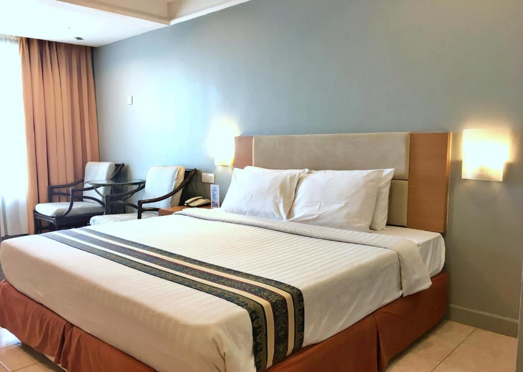 Ένα ή περισσότερα κρεβάτια σε δωμάτιο στο Corus Paradise Resort Port Dickson