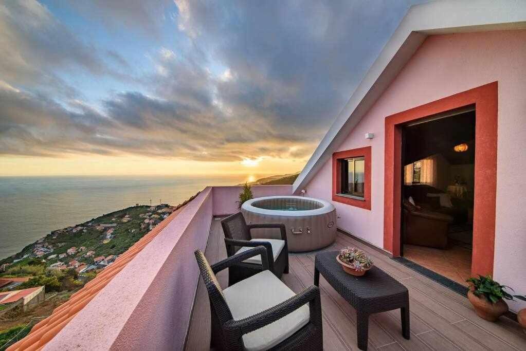 a balcony with a view of the ocean at Lombo Cesteiro Guesthouse in Tábua