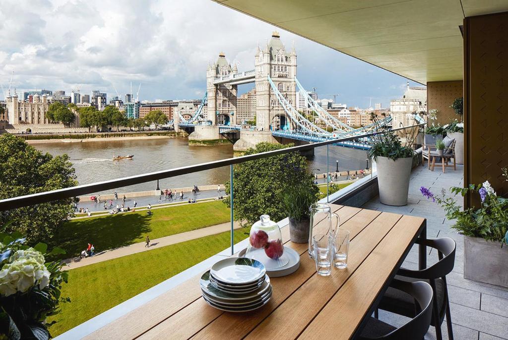 a table on a balcony with a view of the city at 3 Million Pound Luxury Large Tower Bridge Direct Views Sleeps 6 in London