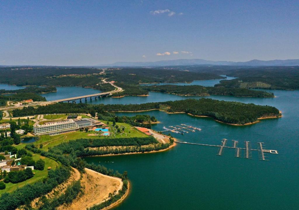 an aerial view of a river with a pier at Montebelo Aguieira Lake Resort & Spa in Mortágua